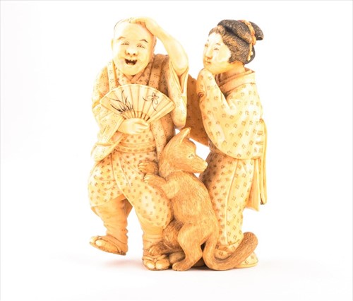 Lot 142 - A Japanese ivory okimono of a laughing couple...