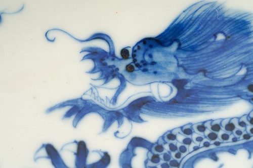 Lot 95 - A Chinese porcelain blue & white dragon bowl,...