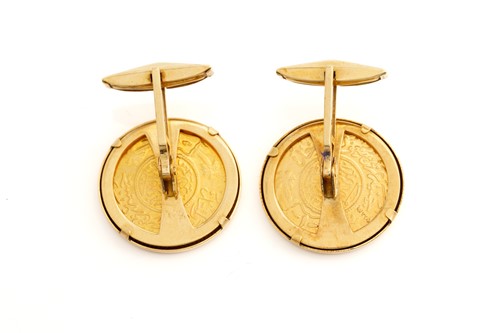 Lot 58 - A pair of coin cufflinks, each features a...