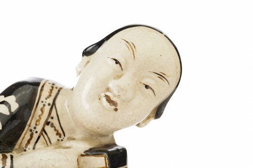 Lot 160 - A Chinese Cizhou figural pillow, Song dynasty...