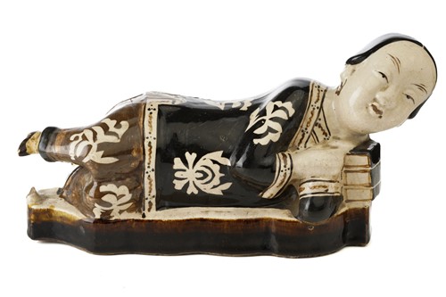 Lot 160 - A Chinese Cizhou figural pillow, Song dynasty...
