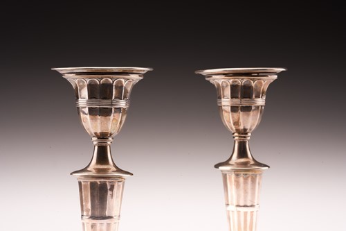 Lot 376 - A pair of George III style silver candlesticks;...