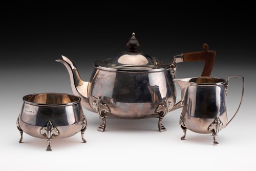 Lot 398 - A silver three piece tea set, the teapot with...