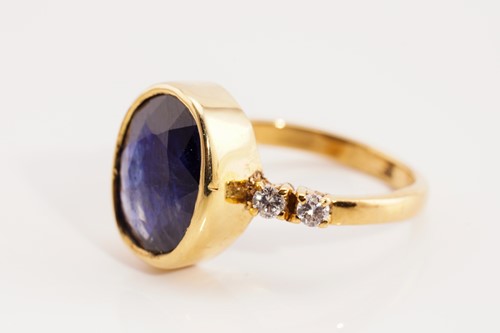 Lot 189 - A glass-filled sapphire and diamond ring in...