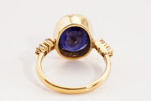 Lot 189 - A glass-filled sapphire and diamond ring in...