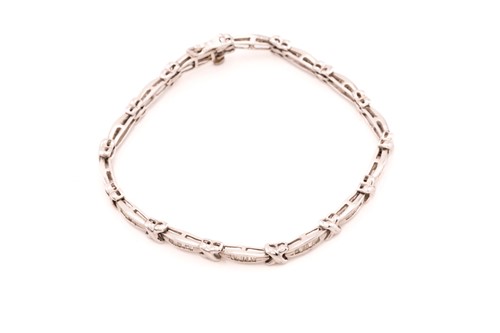 Lot 269 - A diamond line bracelet in 9ct white gold,...
