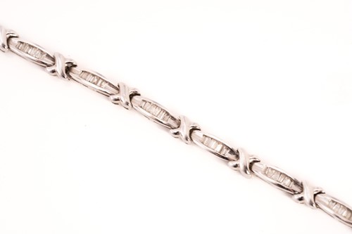 Lot 269 - A diamond line bracelet in 9ct white gold,...