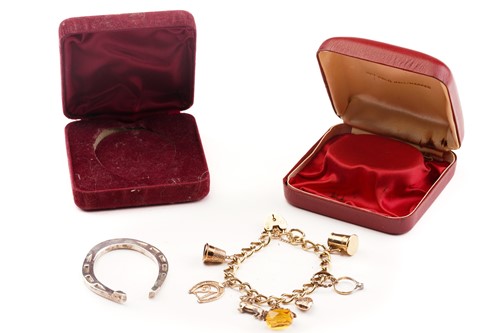 Lot 17 - A 9ct gold charm bracelet, and a silver...
