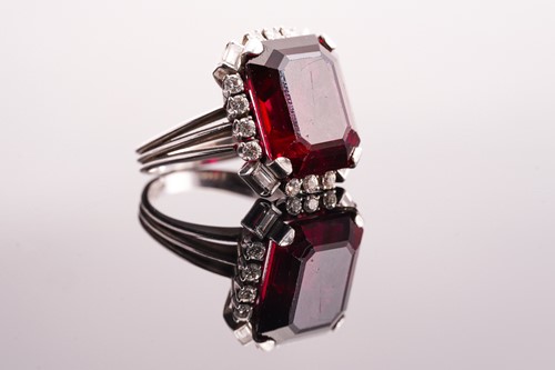 Lot 275 - A rubellite and diamond halo ring, consists of...