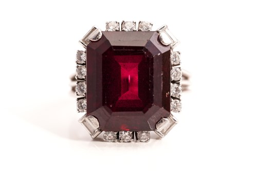 Lot 275 - A rubellite and diamond halo ring, consists of...