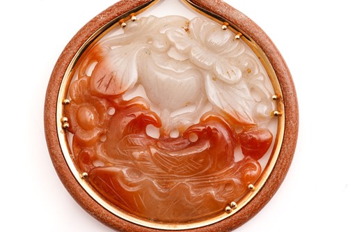 Lot 148 - A Chinese carved jade ‘Magpie and Lotus'...