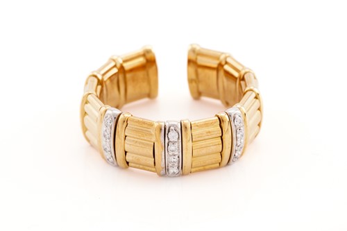 Lot 212 - A two-toned cuff ring set with cubic zirconias,...