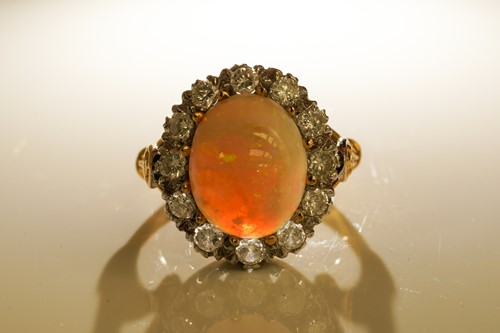 Lot 249 - An opal and diamond entourage ring in 18ct...