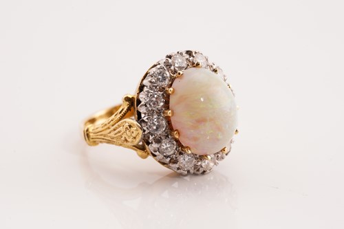 Lot 249 - An opal and diamond entourage ring in 18ct...