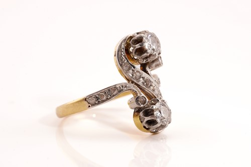 Lot 148 - A diamond Toi et Moi ring, of a twisted 'S'...