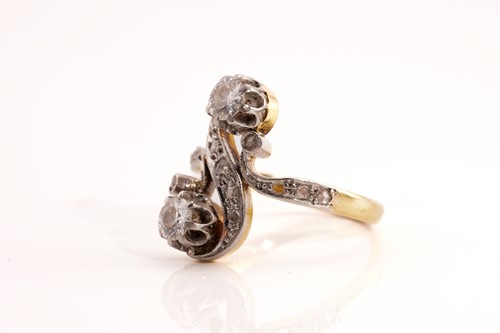 Lot 148 - A diamond Toi et Moi ring, of a twisted 'S'...