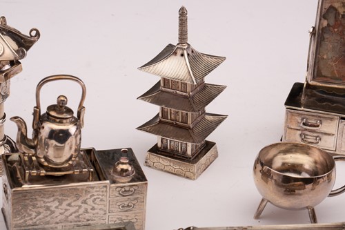 Lot 386 - A collection of Oriental miniature white metal...