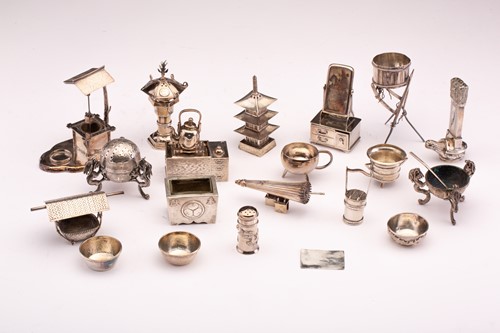 Lot 386 - A collection of Oriental miniature white metal...