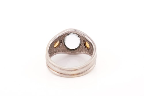 Lot 183 - A three-stone ring centrally set with an oval...