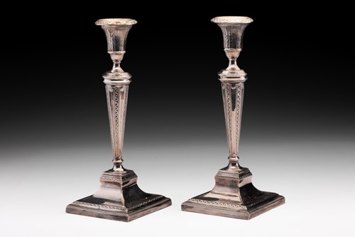 Lot 382 - A pair of Edwardian filled silver candlesticks,...