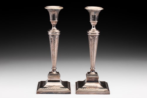 Lot 382 - A pair of Edwardian filled silver candlesticks,...