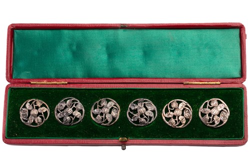 Lot 438 - A cased set of six silver buttons, London 1904...