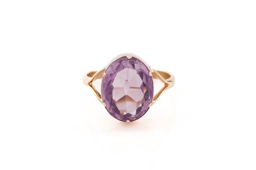Lot 23 - An amethyst ring, consisting of an oval-cut...
