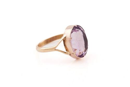 Lot 23 - An amethyst ring, consisting of an oval-cut...