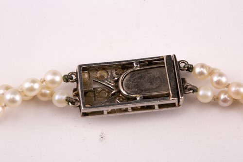 Lot 7 - A two-row graduated pearl necklace with...