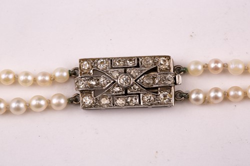 Lot 7 - A two-row graduated pearl necklace with...