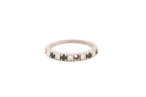 Lot 268 - An emerald and diamond half eternity ring in...