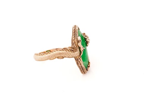 Lot 53 - A Chinese dragon ring set with green jade,...