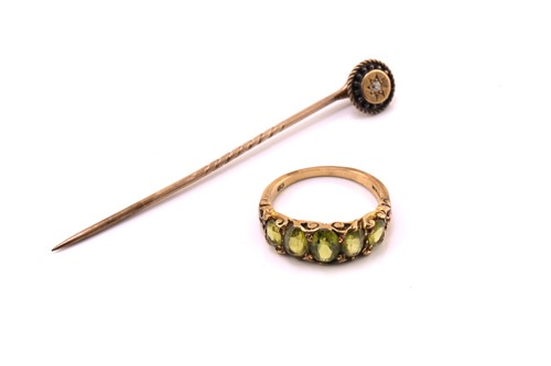 Lot 20 - A five-stone peridot half hoop ring and an...