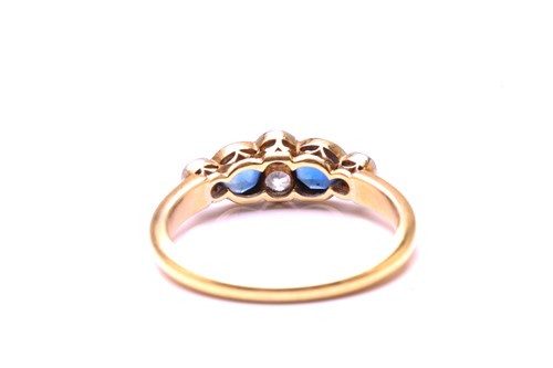 Lot 11 - A sapphire and diamond half hoop ring in 18ct...
