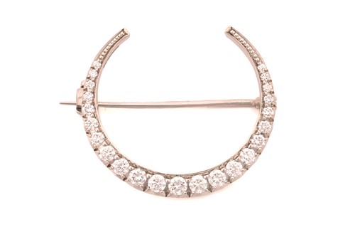 Lot 87 - A diamond-set crescent brooch in 18ct white...