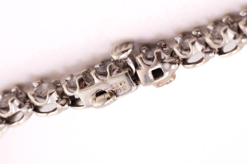 Lot 89 - A diamond line bracelet in 9ct white gold,...