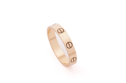 Lot 18 - Cartier 'Love' ring. The polished 18 carat...