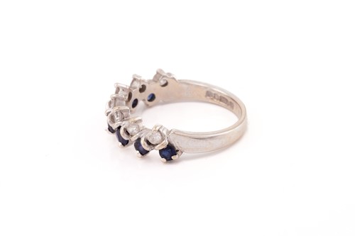 Lot 132 - A two-row sapphire and diamond ring in 18ct...