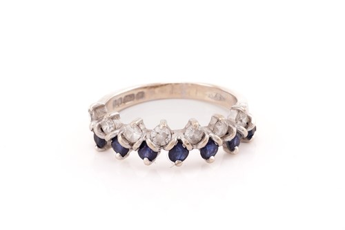 Lot 132 - A two-row sapphire and diamond ring in 18ct...