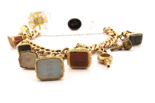 Lot 10 - A charm bracelet with assorted intaglio fob...