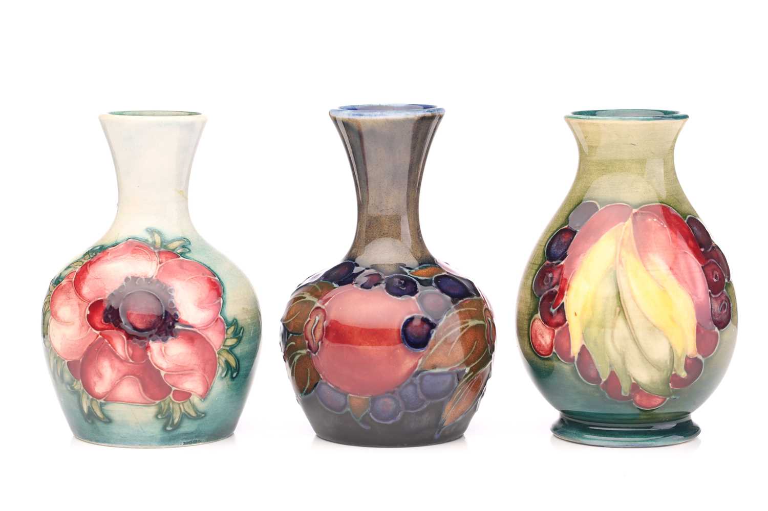 Lot 143 Three Moorcroft small vases, 'Pomegranate'