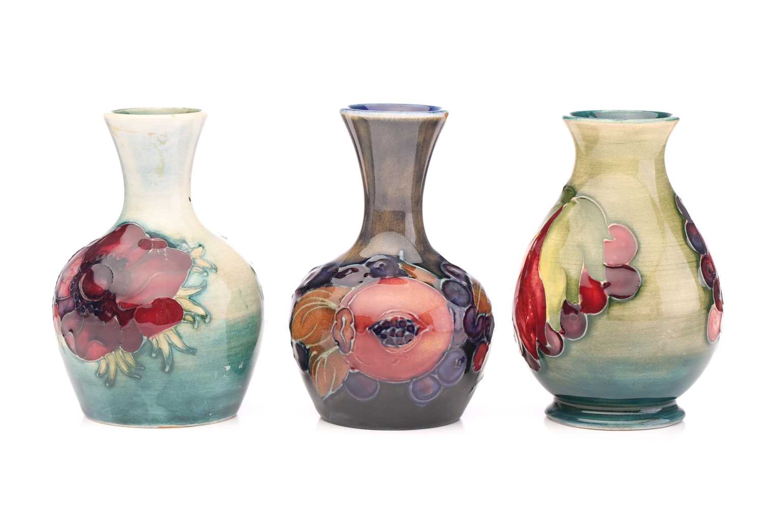 Lot 143 - Three Moorcroft small vases, 'Pomegranate'