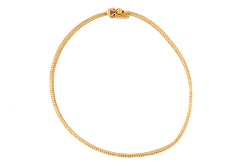 Lot 90 - A flat snake link bracelet, in yellow metal...