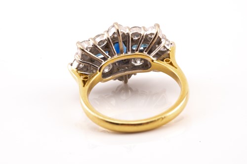 Lot 100 - A sapphire and diamond cluster ring in 18ct...