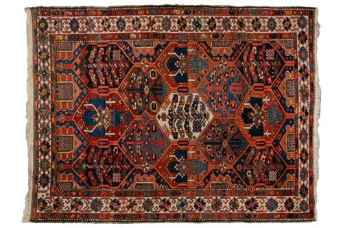 Lot 324 - A Baktiari rug, the red ground filled with...