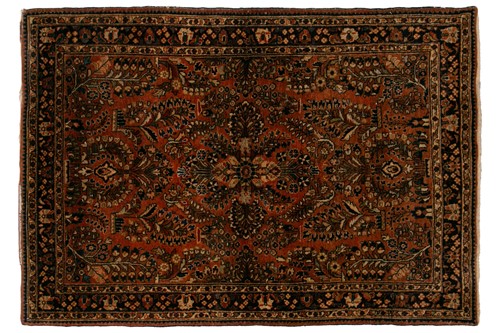 Lot 334 - An old sarouk rug with a central medallion and...