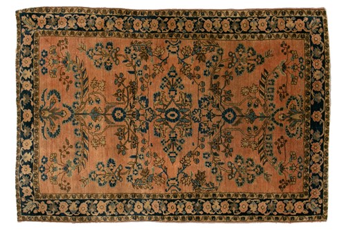 Lot 307 - An old Sarouk rug with floral sprays on a...