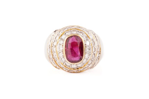Lot 54 - A ruby and diamond dress ring, containing an...