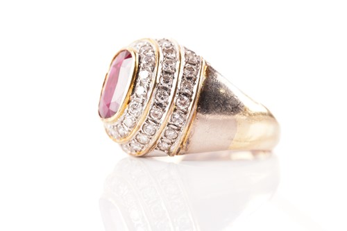 Lot 54 - A ruby and diamond dress ring, containing an...