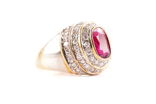 Lot 54 - A ruby and diamond dress ring, containing an...